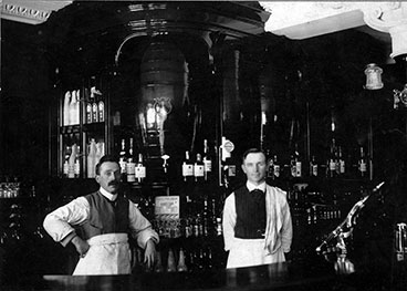 Interior image of M Fearon with Michael Fearon on the left with head barman on the right.